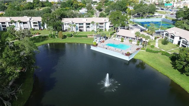 an aerial view of residential houses with outdoor space and swimming pool