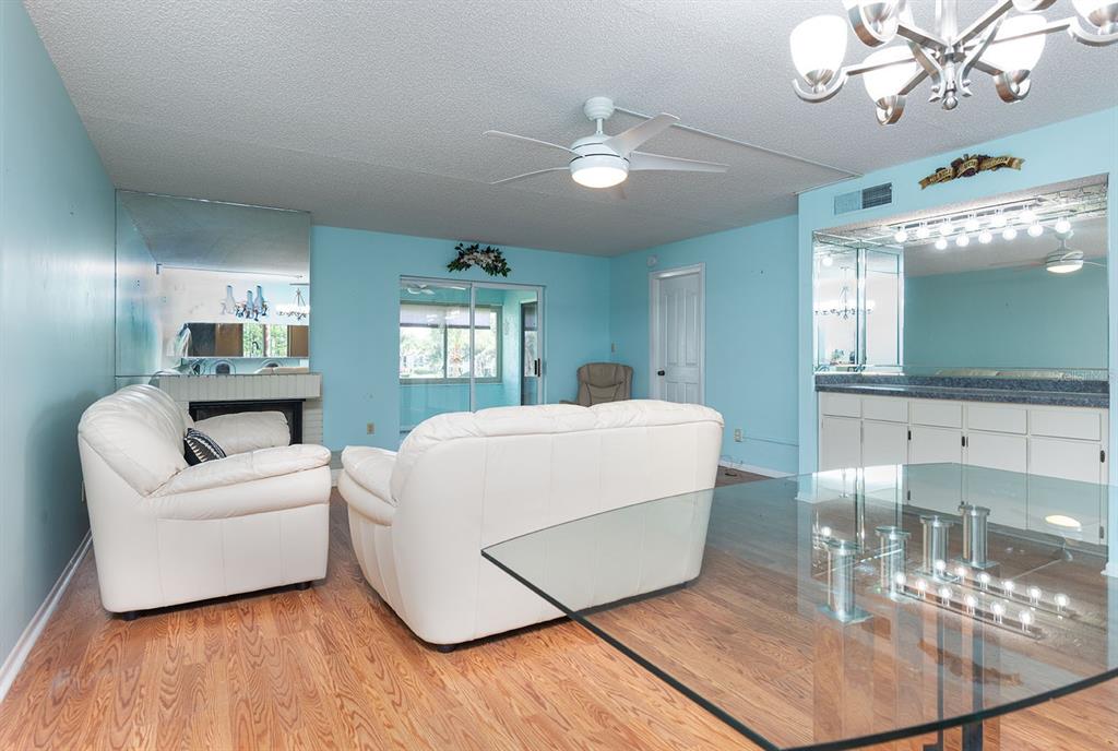 3 Escondido Circle, Unit 8 Altamonte Springs, FL 32701 - Photo 11 of 29 a living room with furniture and a chandelier