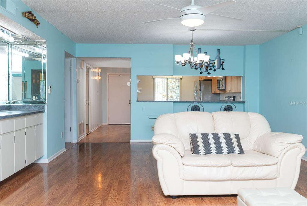3 Escondido Circle, Unit 8 Altamonte Springs, FL 32701 - Photo 12 of 29 a living room with a bed and chandelier