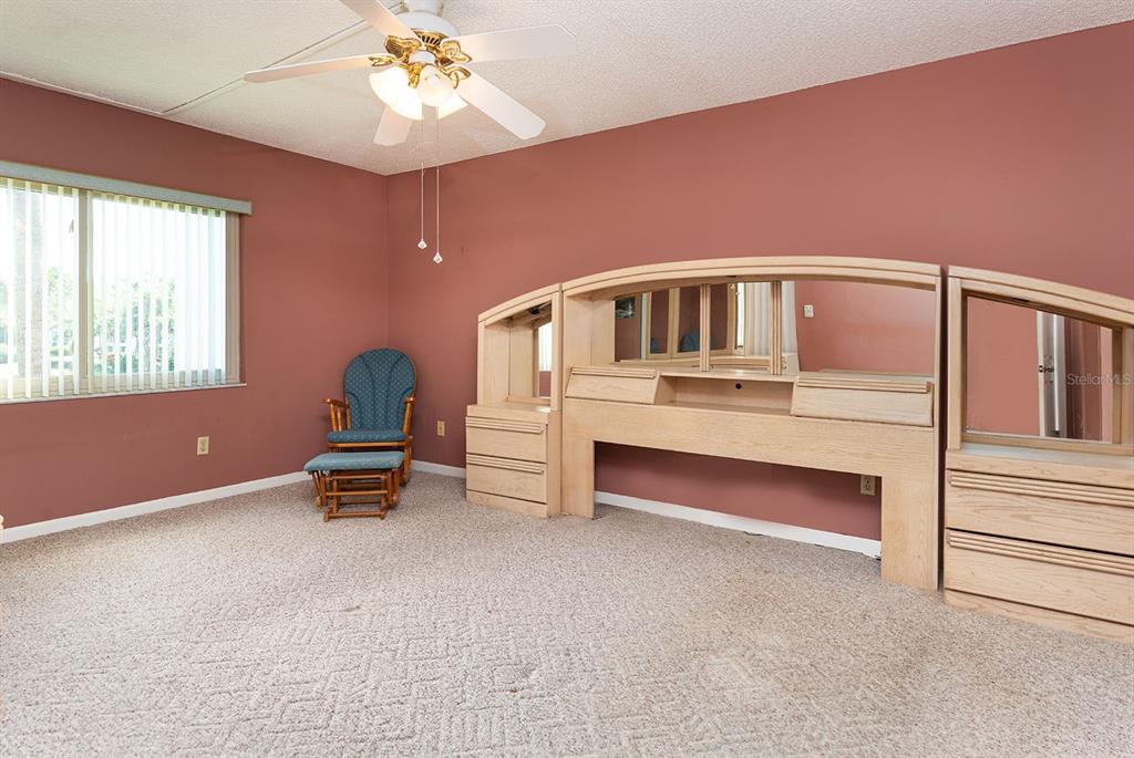 3 Escondido Circle, Unit 8 Altamonte Springs, FL 32701 - Photo 14 of 29 a bedroom with furniture and window