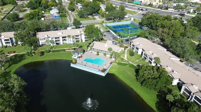an aerial view of a house with a yard basket ball court and outdoor seating