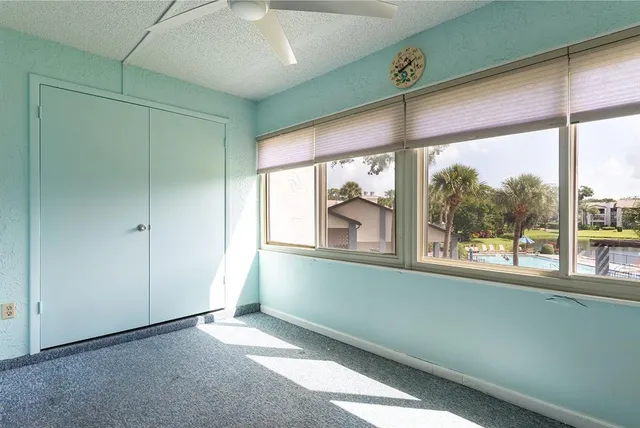 an empty room with large windows