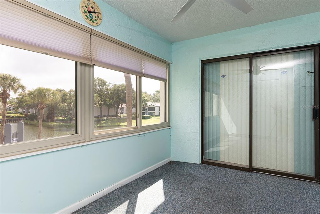 3 Escondido Circle, Unit 8 Altamonte Springs, FL 32701 - Photo 28 of 29 an empty room with large windows