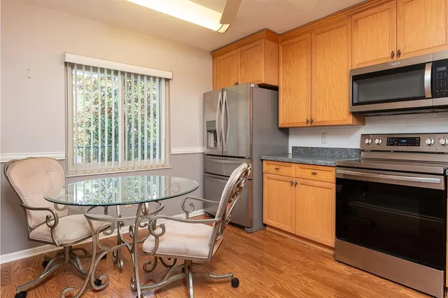 a kitchen with stainless steel appliances granite countertop a stove a sink dishwasher a microwave oven with granite countertops and cabinets