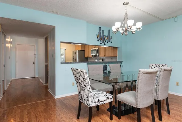 a view of a dining room with furniture and chandelier