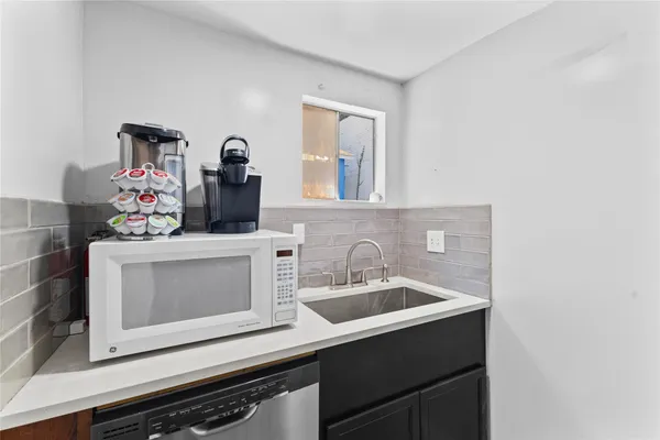 a bathroom with a sink and a microwave