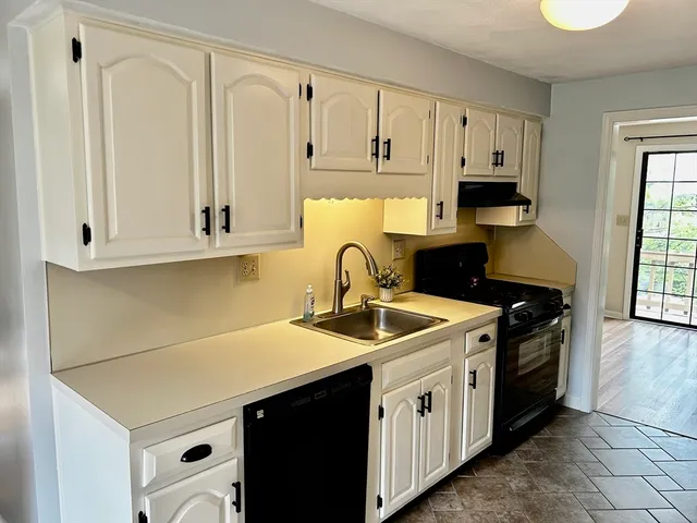 a kitchen with stainless steel appliances granite countertop a sink stove and cabinets