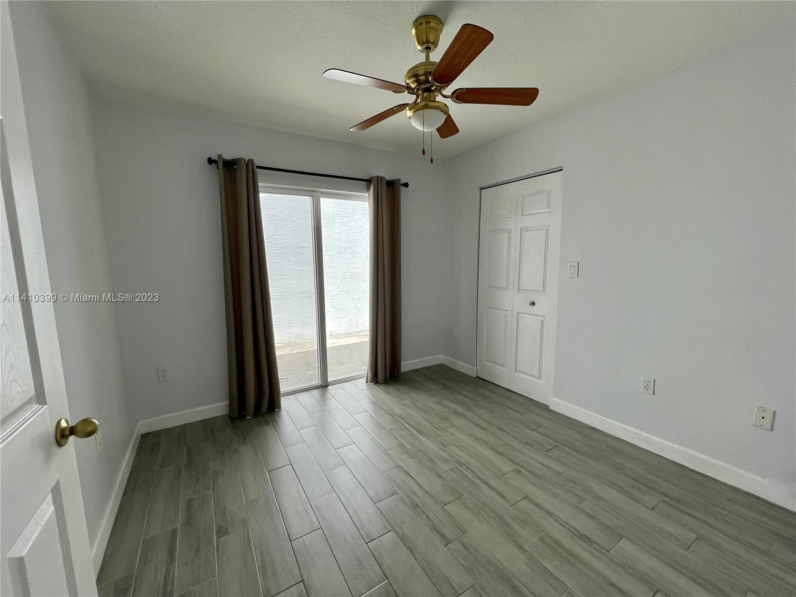 12030 Southwest 135th Terrace Miami, FL 33186 - Photo 14 of 27 an empty room to hallway with wooden floor