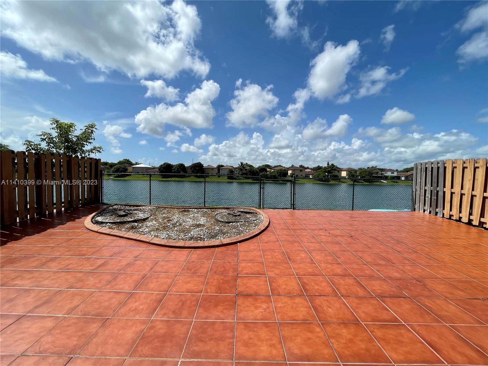12030 Southwest 135th Terrace Miami, FL 33186 - Photo 18 of 27 a view of a swimming pool with a yard