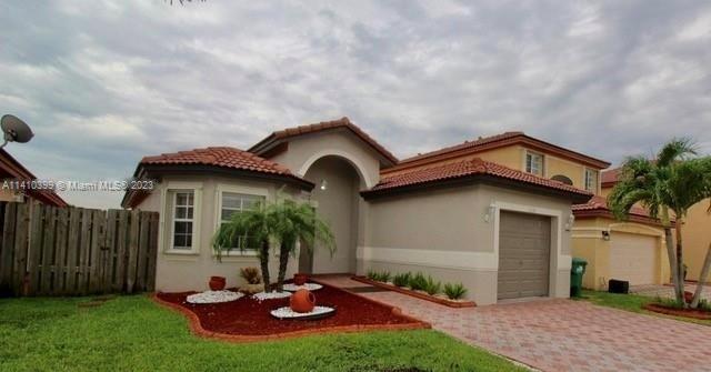 12030 Southwest 135th Terrace Miami, FL 33186 - Photo 7 of 27 a front view of a house with a yard