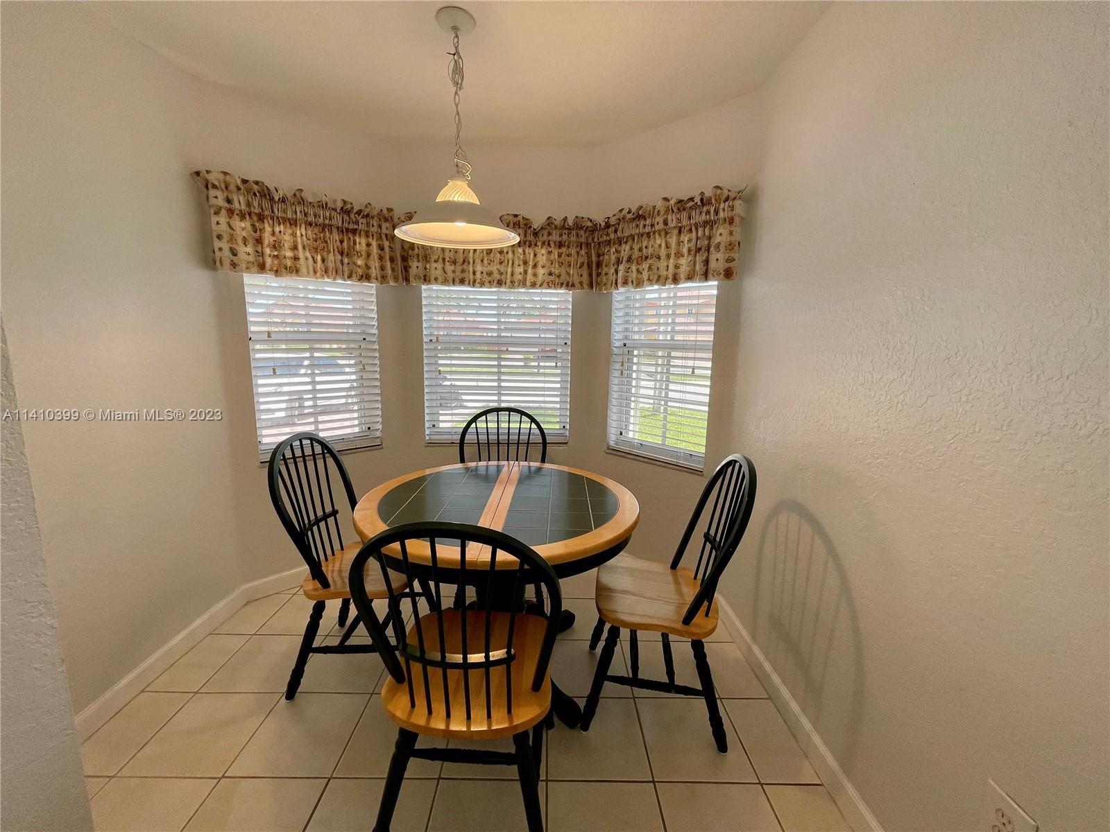 12030 Southwest 135th Terrace Miami, FL 33186 - Photo 8 of 27 a dining room with furniture and window