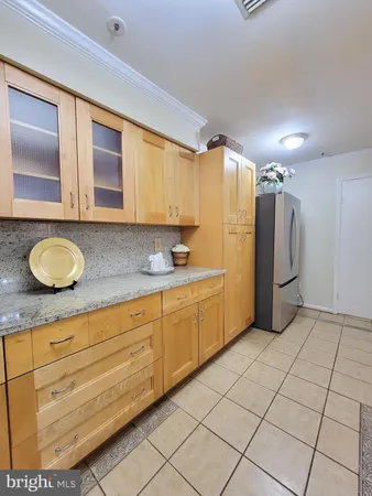 a spacious bathroom with a granite countertop sink and a mirror