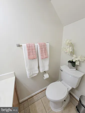 a white toilet sitting next to a bathroom sink