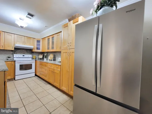 a kitchen with stainless steel appliances a refrigerator sink and cabinets