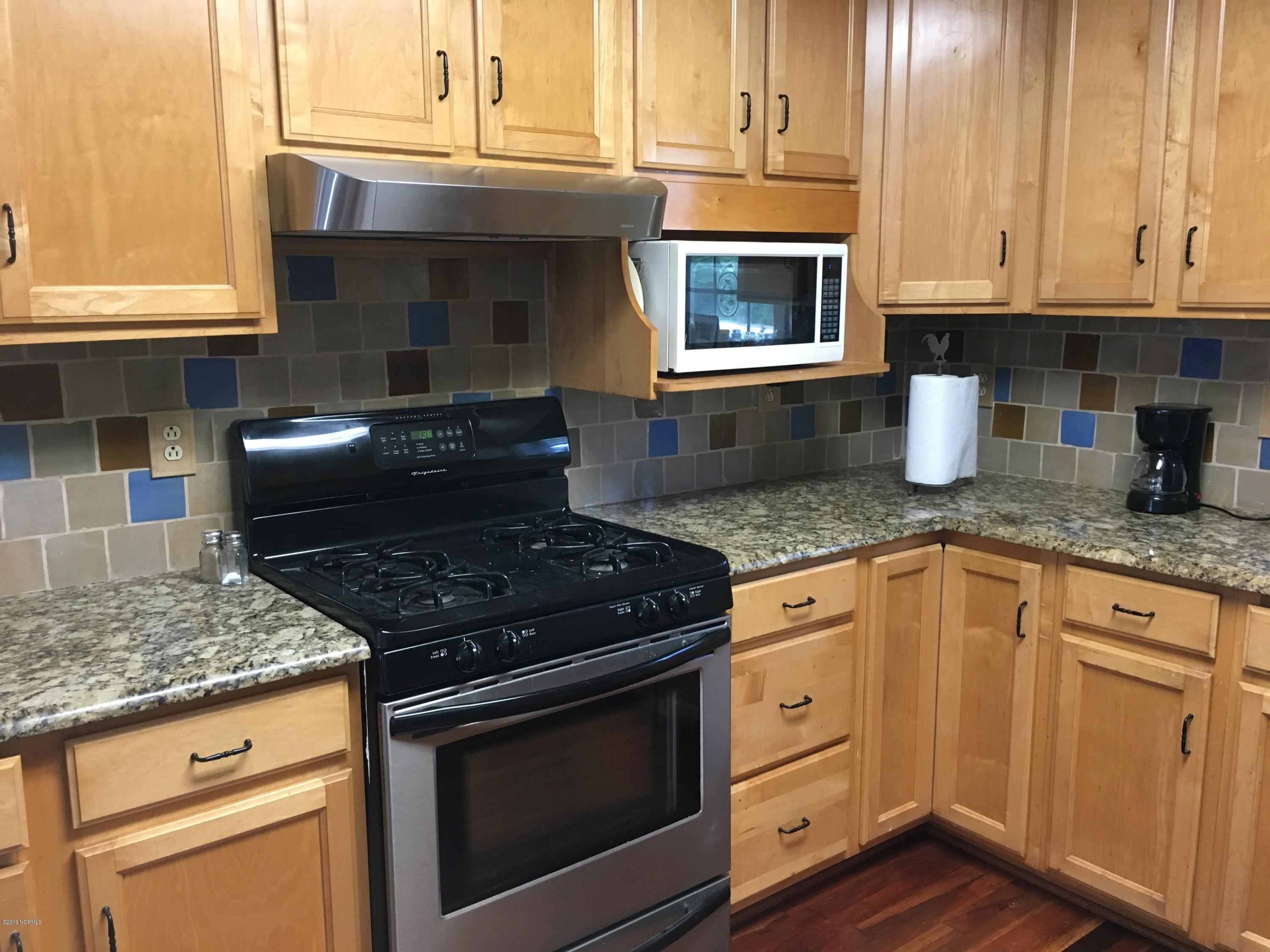 4958 St Rose Church Road Sims, NC 27880 - Photo 9 of 22 Kitchen has granite countertops and gas stove.