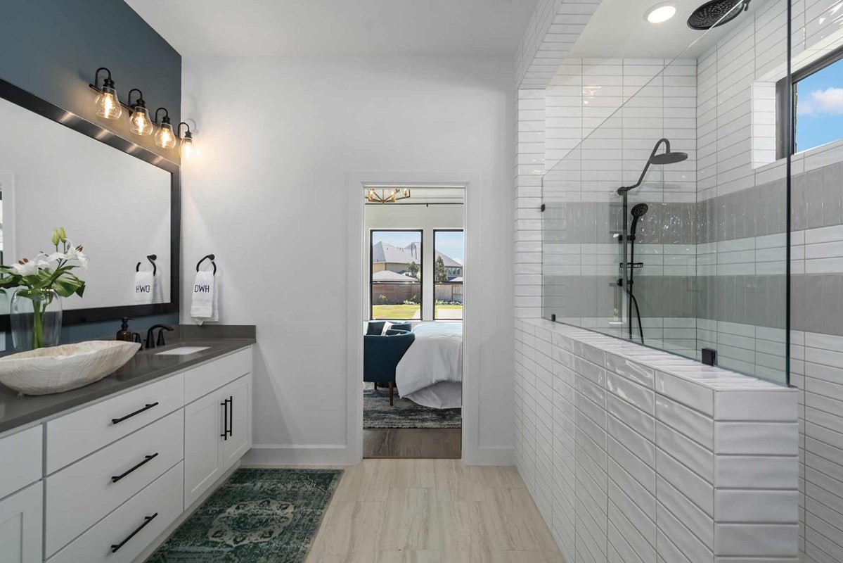 235 Painters Ridge Court Willis, TX 77318 - Photo 11 of 19 a en suite bathroom with a granite countertop sink a mirror and shower