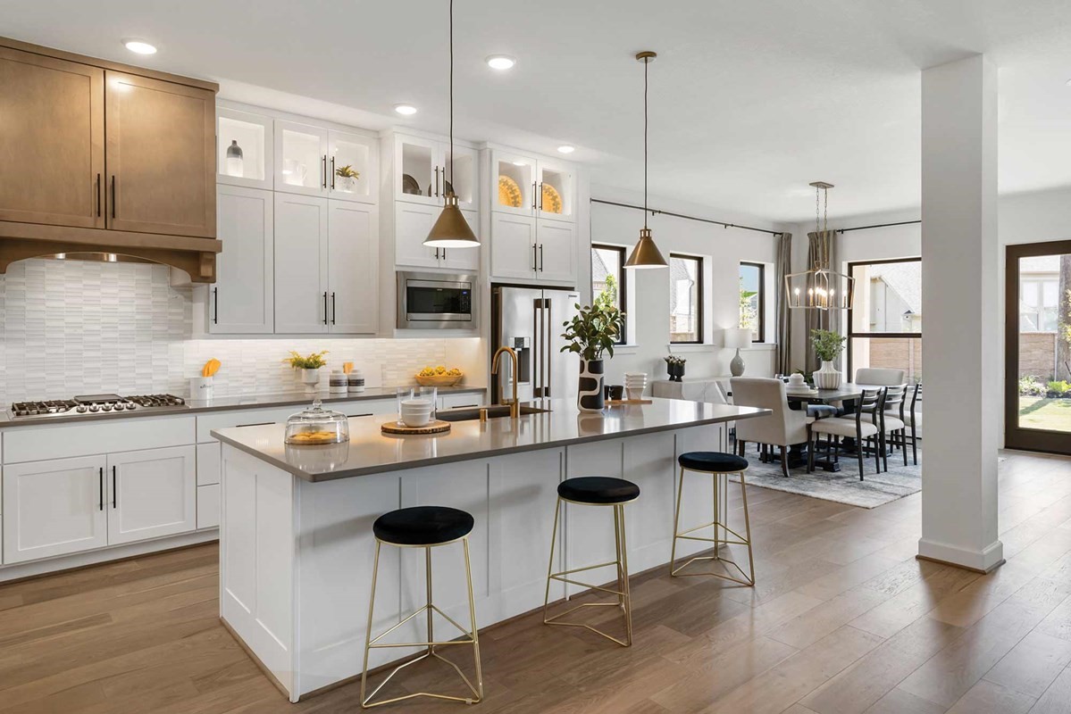 235 Painters Ridge Court Willis, TX 77318 - Photo 6 of 19 a kitchen with counter space sink refrigerator and chairs