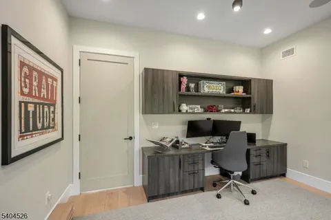 a front view of house with yard and trees in the background