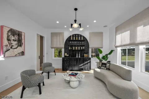 a view of a dining room with furniture a rug and wooden floor