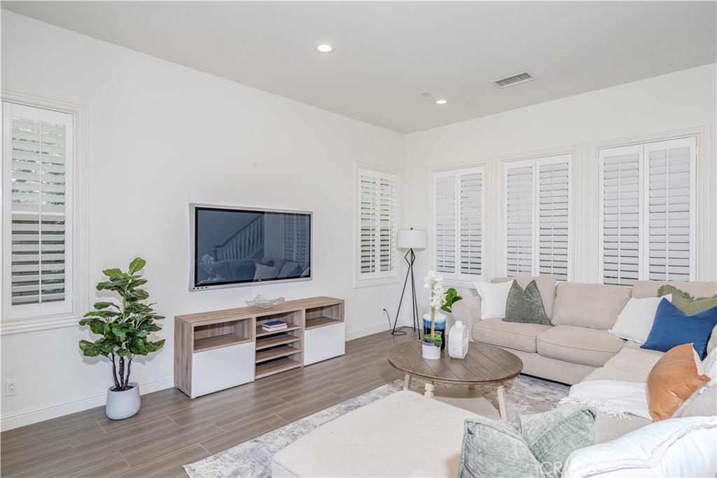 11 Barberry Lake Forest, CA 92630 - Photo 15 of 64 a living room with furniture potted plant and a flat screen tv