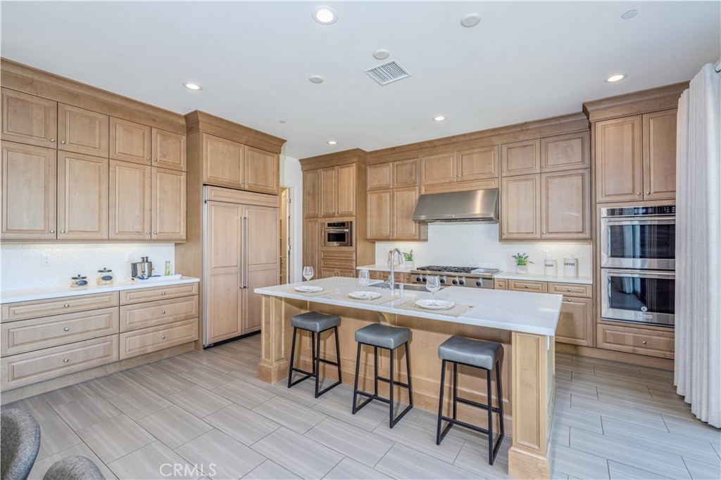 11 Barberry Lake Forest, CA 92630 - Photo 5 of 64 a kitchen with a sink a stove a refrigerator and cabinets