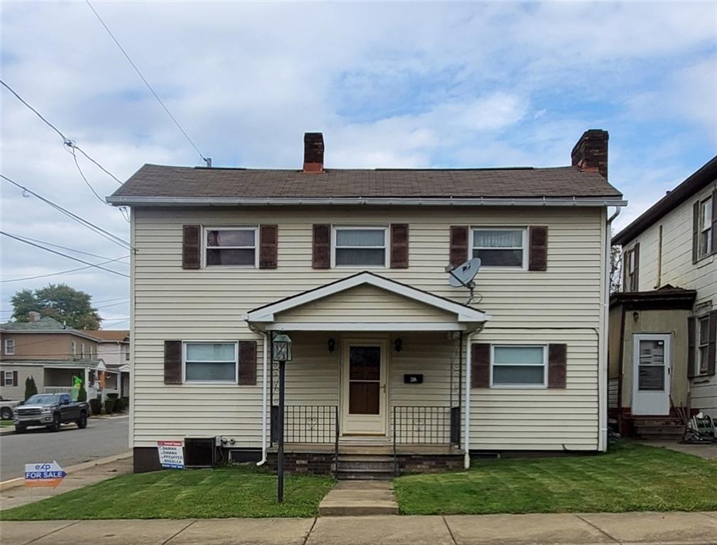 452 Jefferson Street Rochester, PA 15074 - Photo 1 of 18 a front view of a house with a yard