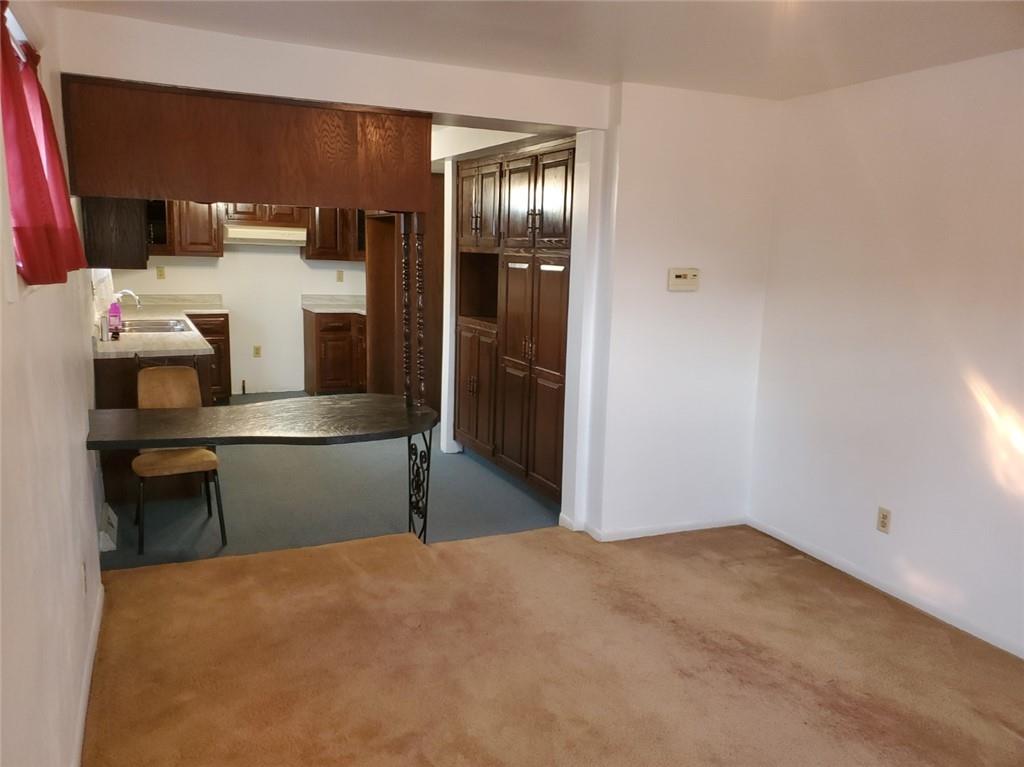 452 Jefferson Street Rochester, PA 15074 - Photo 4 of 18 a kitchen with a refrigerator and table
