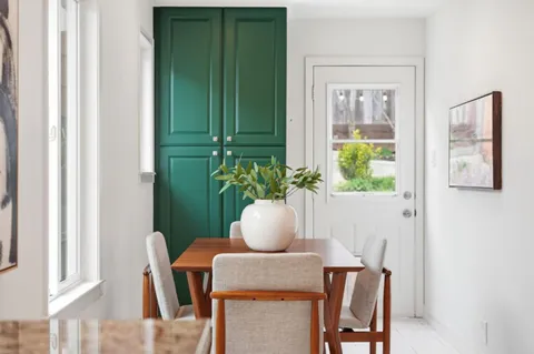 a dining room with furniture and a window