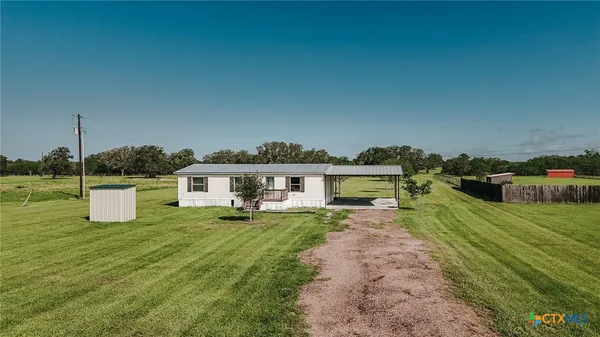 a house view with a sitting space and garden