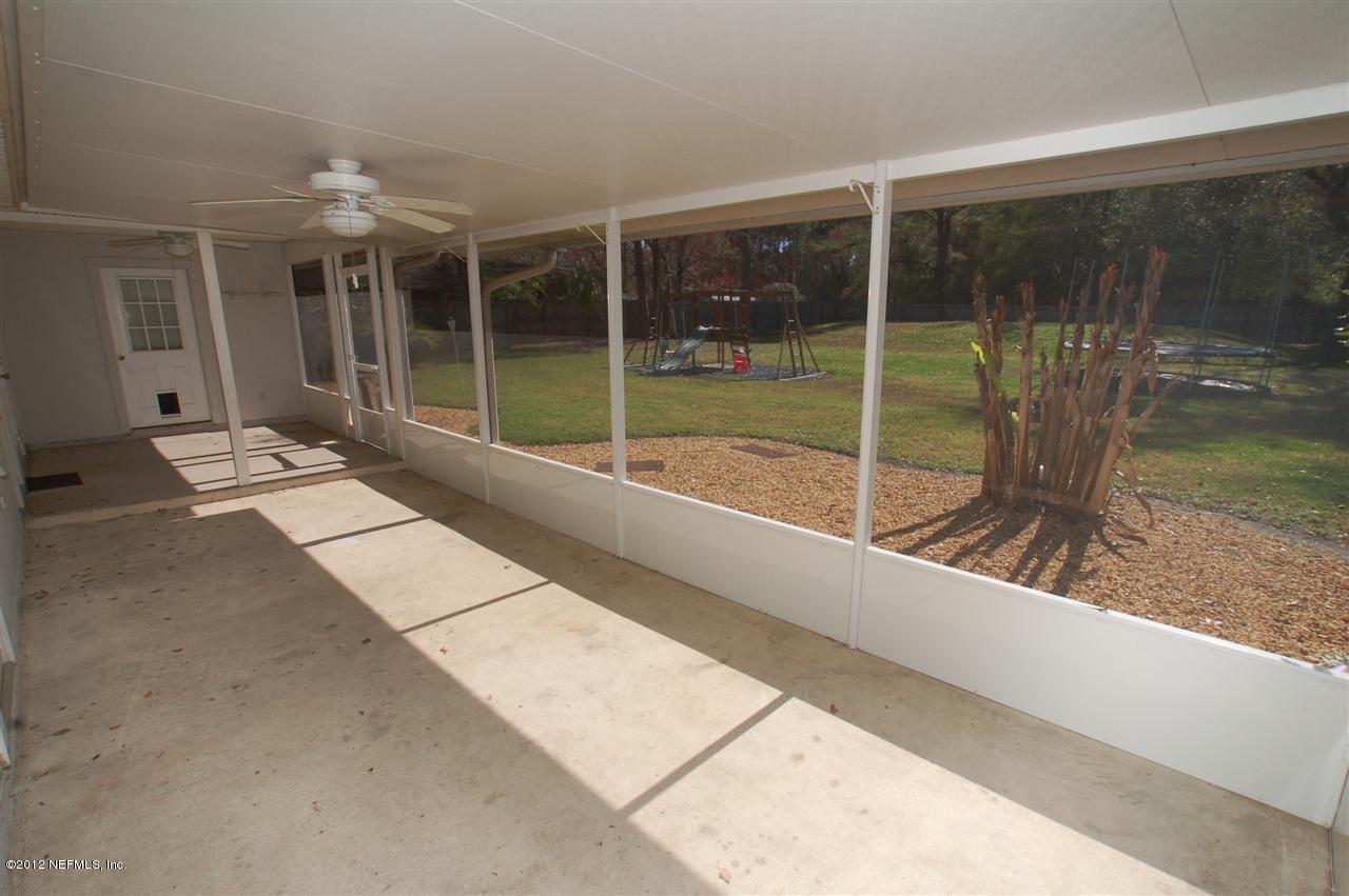 136 Old Hard Road Fleming Island, FL 32003 - Photo 27 of 35 Screened lanai overlooking large yard.