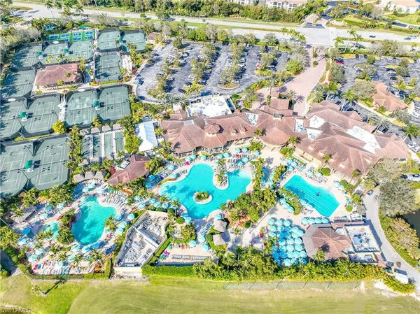 an aerial view of residential houses with outdoor space and swimming pool