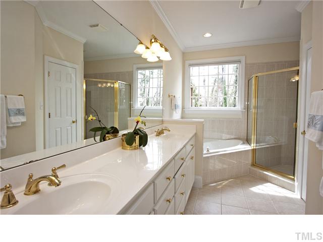 3312 Tall Tree Place Raleigh, NC 27607 - Photo 9 of 12 Master Bath with higher dual vanities, and gorgeous tiled whirlpool. Separate tiled custom shower adds a special luxury to this bath/spa. Separate private room for water closet.