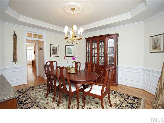 3312 Tall Tree Place Raleigh, NC 27607 - Photo 10 of 12 Deep crown moulding, paneled wainscotting, hardwood floors and a classic chandelier distinguishes the formal dining room. Long after dinner is over, guests are sure to linger over dessert and conversation in this handsome room.