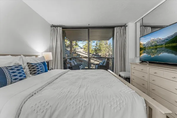 a bedroom with a bed and a flat screen tv