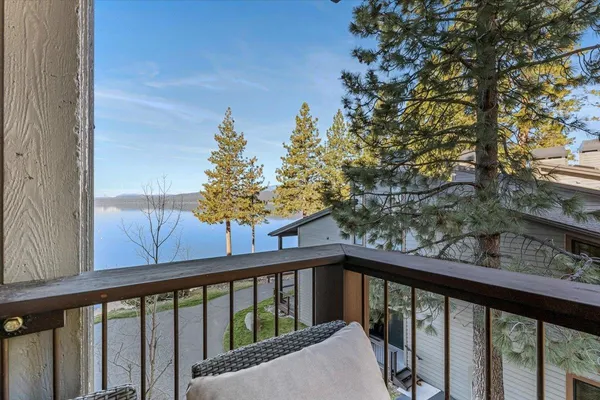 a large kitchen with stainless steel appliances granite countertop a stove top oven a sink dishwasher a dining table and chairs with wooden floor