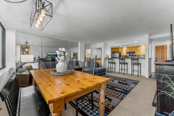 a dining room with furniture a chandelier and pool table