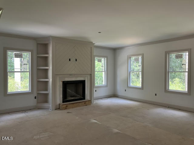 119 Big Pine Road Clayton, NC 27520 - Photo 4 of 21 an empty room with windows and fireplace