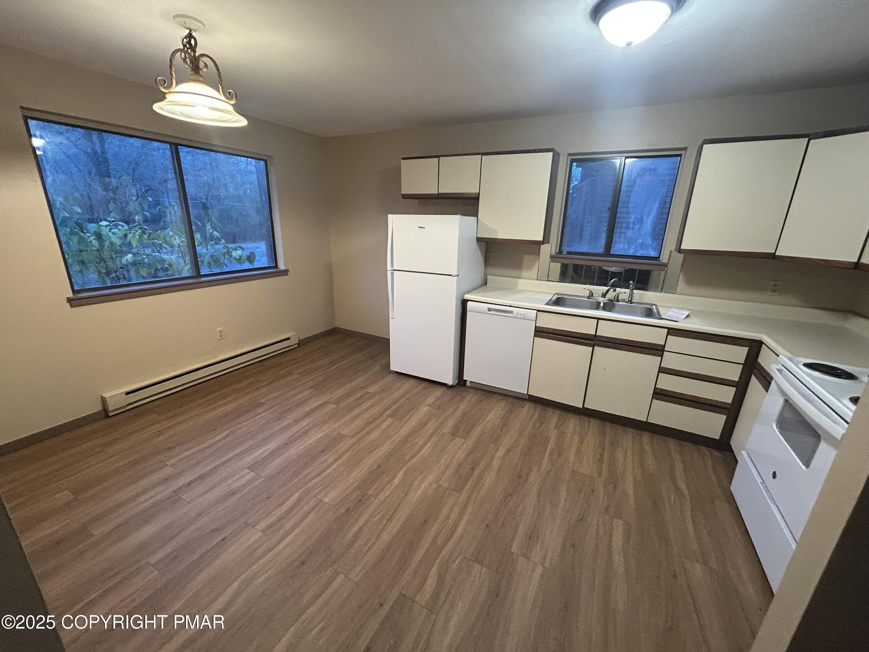 233 Sedburgh Court Bushkill, PA 18324 - Photo 3 of 14 a kitchen with wooden floors and wooden cabinets