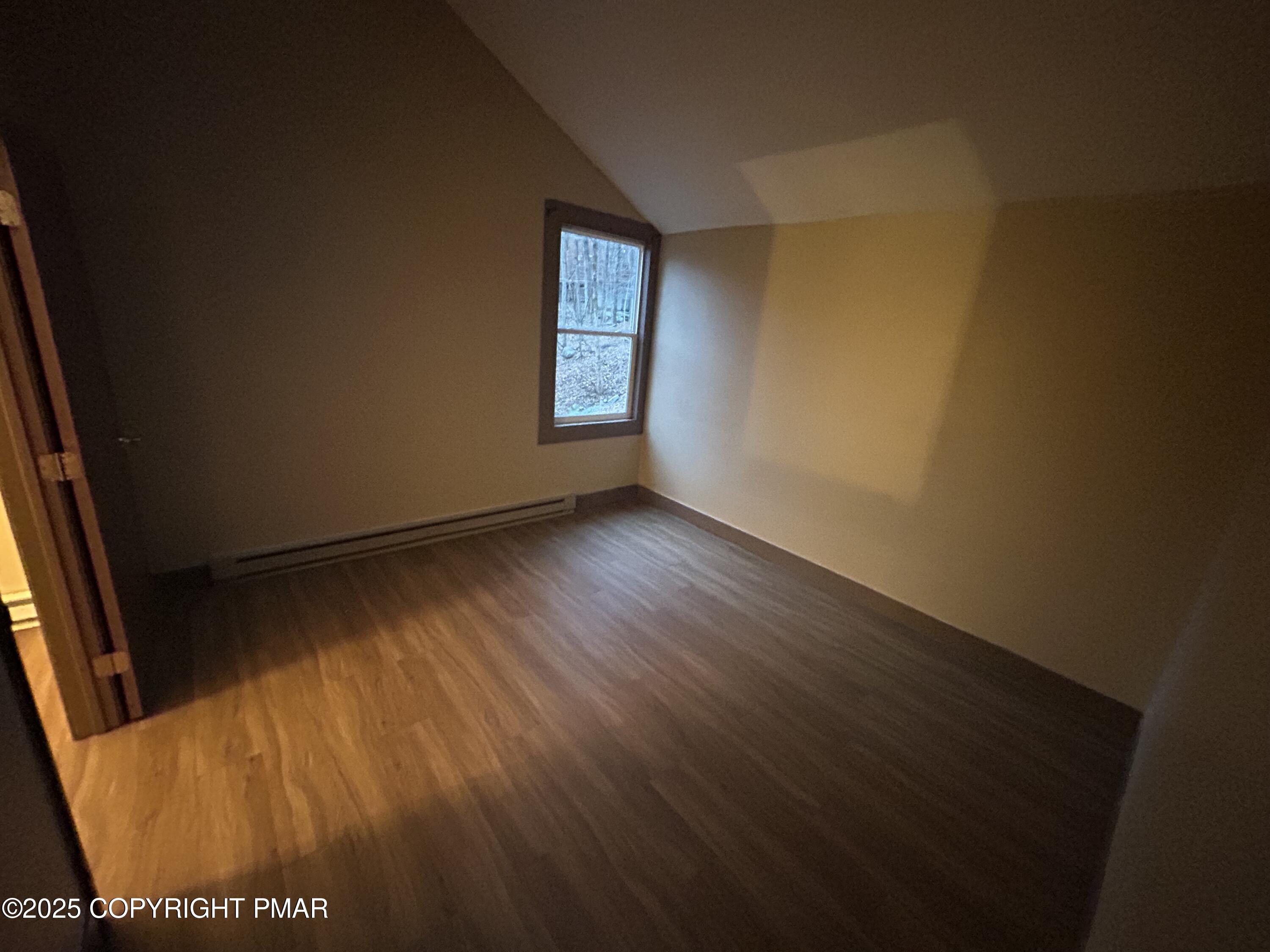 233 Sedburgh Court Bushkill, PA 18324 - Photo 9 of 14 a view of an empty room with wooden floor and a window