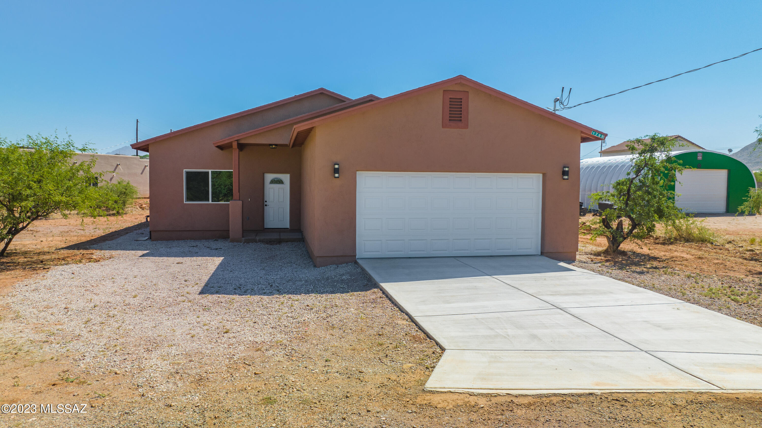 1799 Saltillo Court Rio Rico, AZ 85648 - Photo 23 of 25 a front view of a house with a yard and garage
