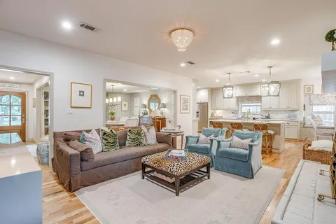 a living room with furniture and view of kitchen