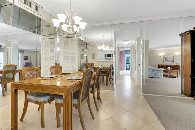 a view of a dining room with furniture and a chandelier