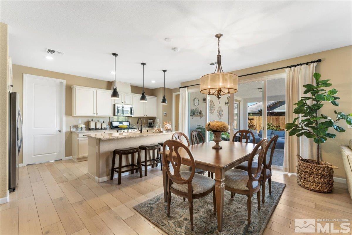 2315 Trakehner Lane Reno, NV 89521 - Photo 12 of 40 a dining room with furniture potted plants and wooden floor