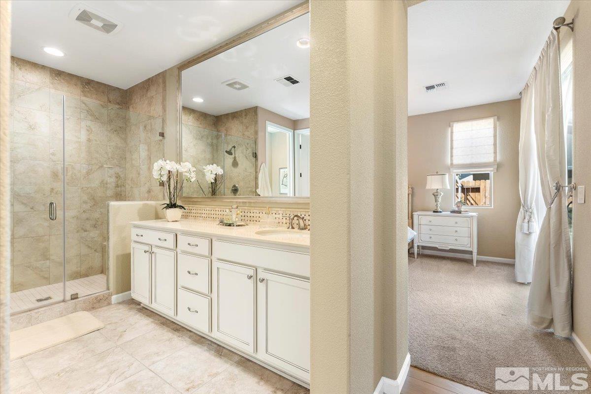 2315 Trakehner Lane Reno, NV 89521 - Photo 17 of 40 a en suite bathroom with a granite countertop sink mirror and shower