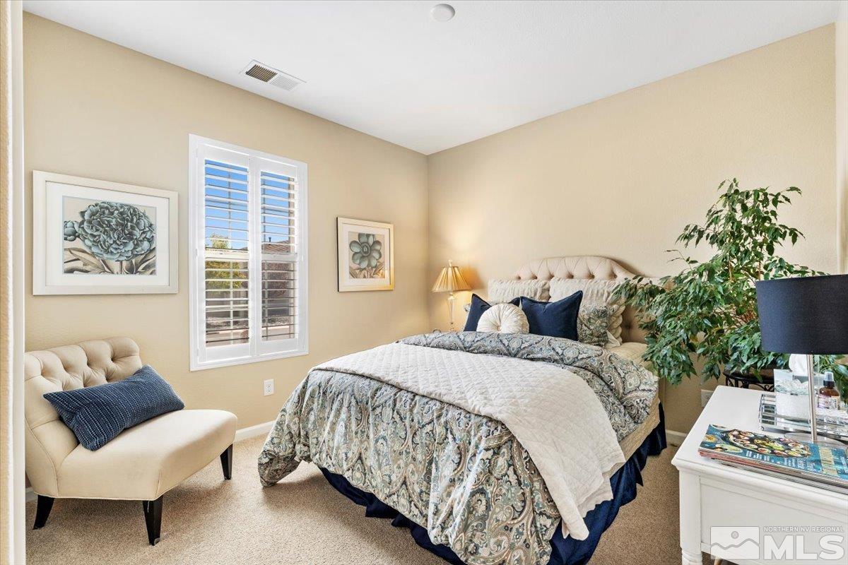 2315 Trakehner Lane Reno, NV 89521 - Photo 20 of 40 a bedroom with a bed and a couch