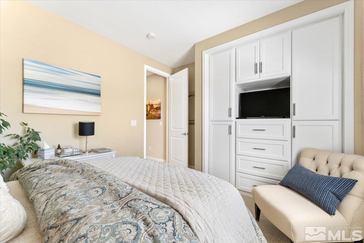 2315 Trakehner Lane Reno, NV 89521 - Photo 21 of 40 a bedroom with a bed and flat screen tv