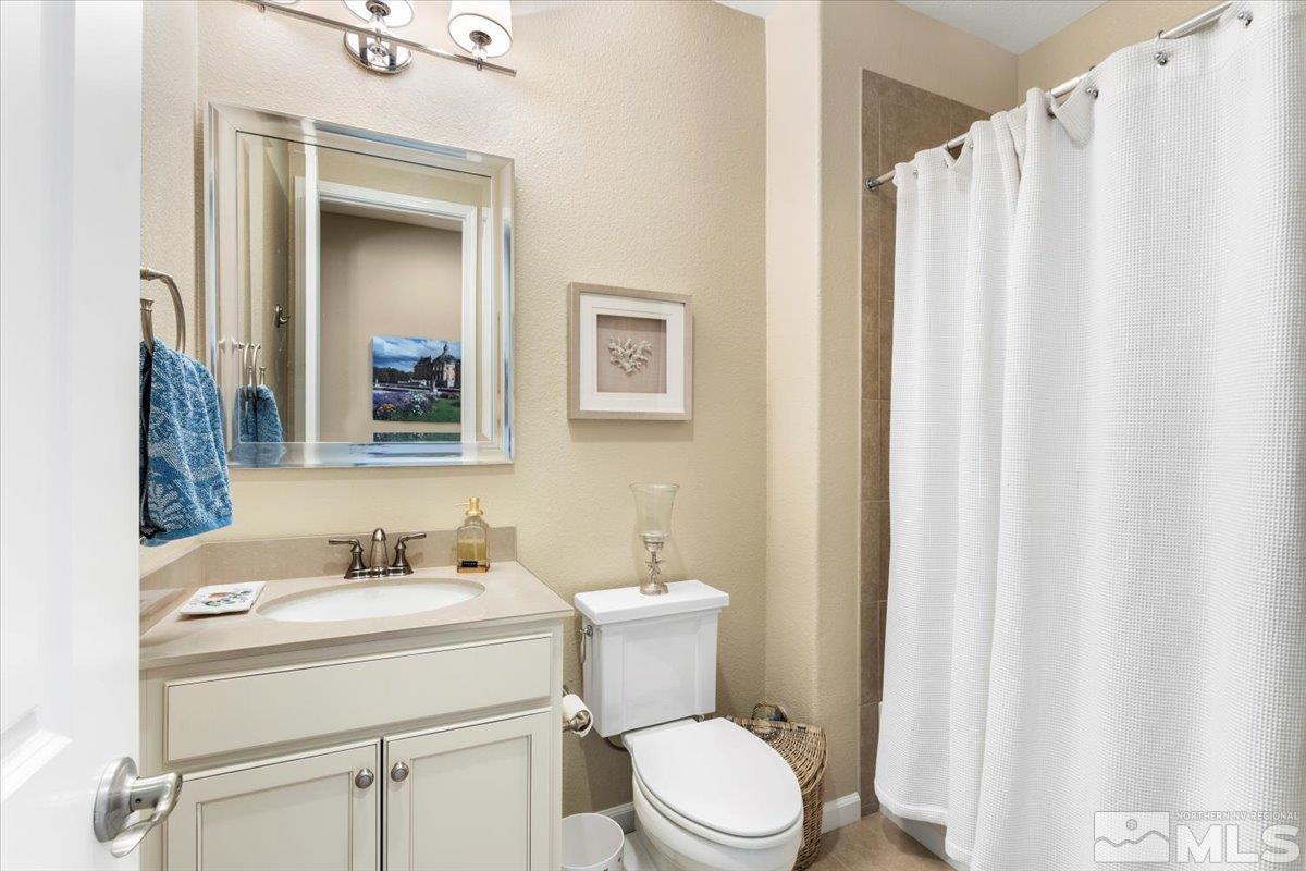 2315 Trakehner Lane Reno, NV 89521 - Photo 22 of 40 a bathroom with a sink a toilet and shower curtain