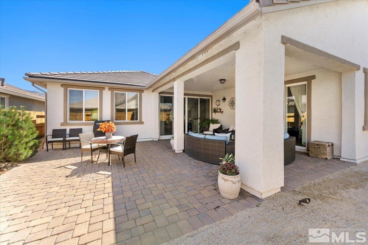 2315 Trakehner Lane Reno, NV 89521 - Photo 30 of 40 a view of a patio with dining table and chairs and potted plants