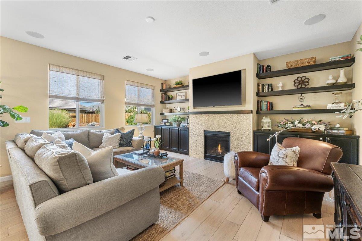 2315 Trakehner Lane Reno, NV 89521 - Photo 8 of 40 a living room with furniture a flat screen tv and a fireplace