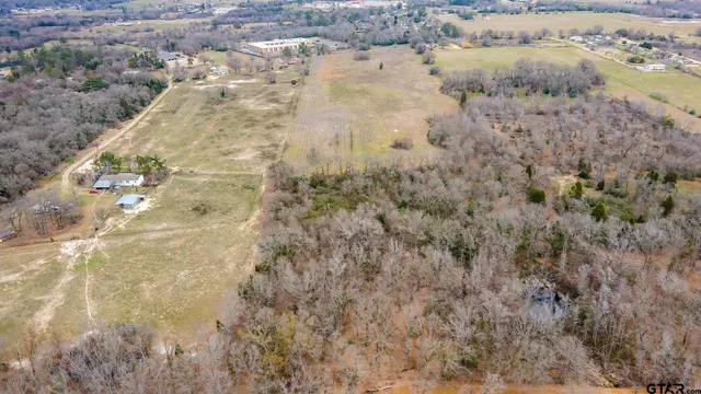 a view of a dry yard with wooden fence